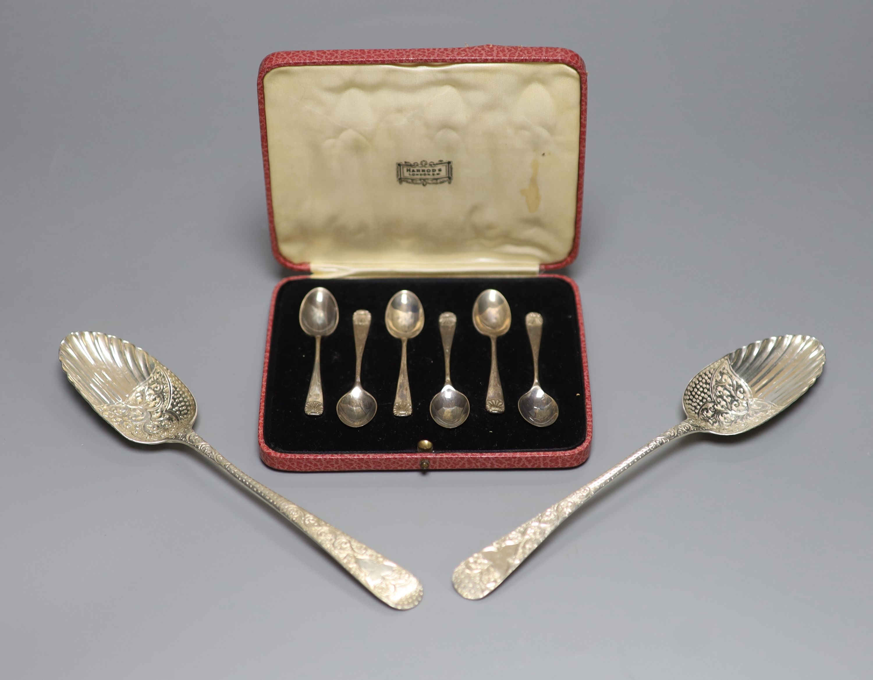 Two similar George III silver berry spoons, London, 1805 & 1814 and a cased set of six silver coffee spoons.